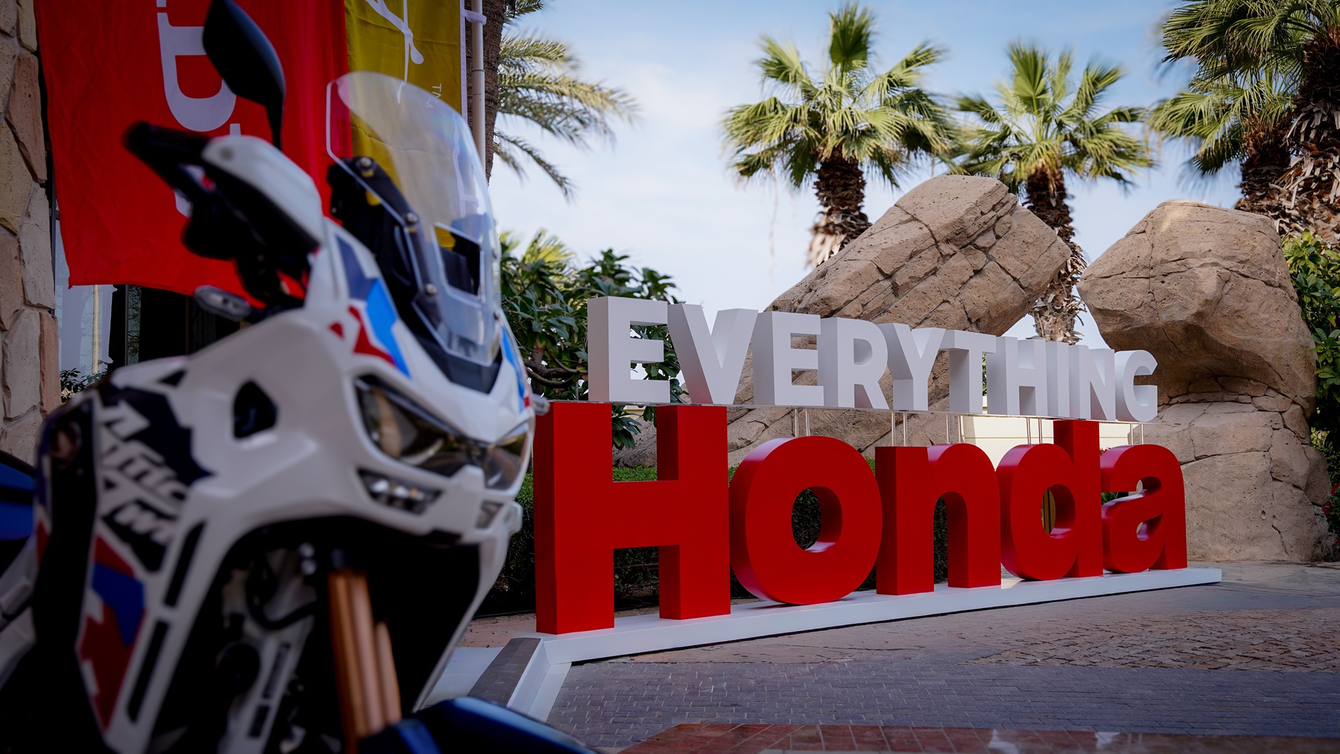 Honda motorcycle parked outdoors, next to the 'Everything Honda' signage at Sofitel The Palm in Dubai