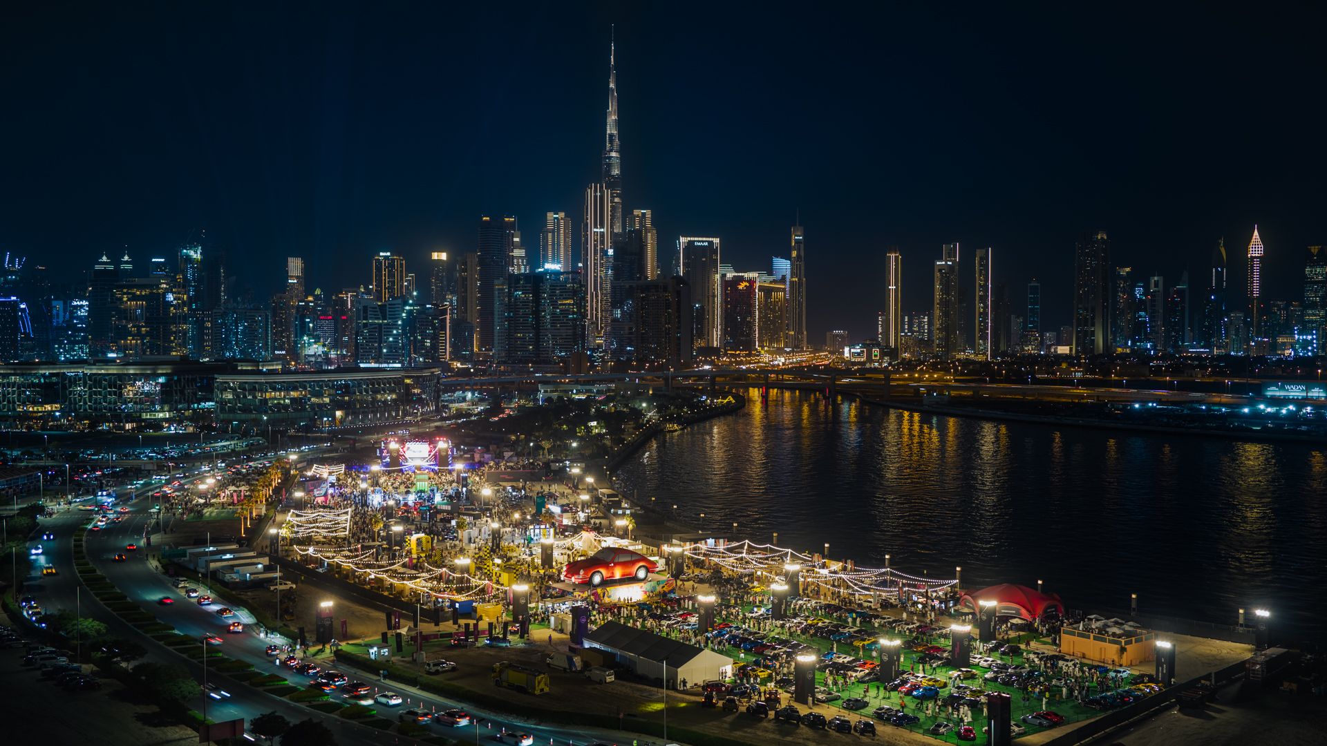 The full-scale photograph of the Icons of Porsche 2025 at night