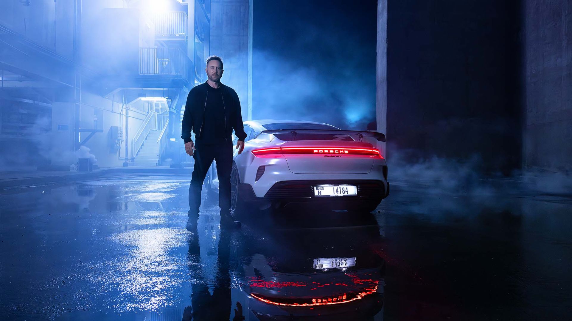 David Guetta next to a white Porsche 911 during the launch of the Speed of Light campaign