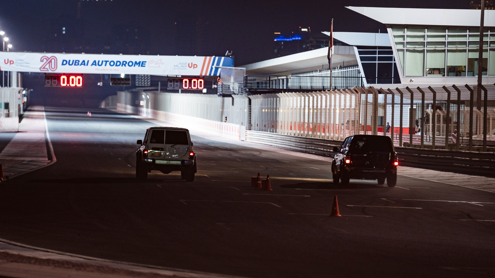 Night shot: Two performance SUVs line up at the start line at Dubai Autodrome.