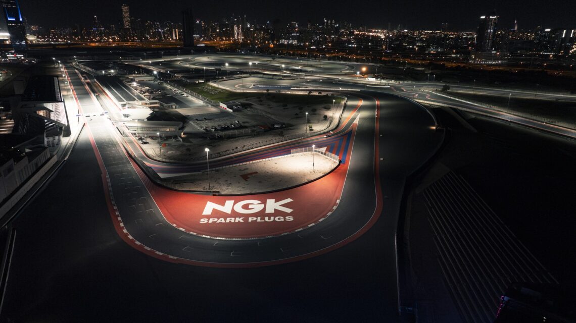 Wide shot of the entire Dubai Autodrome track and facility at night