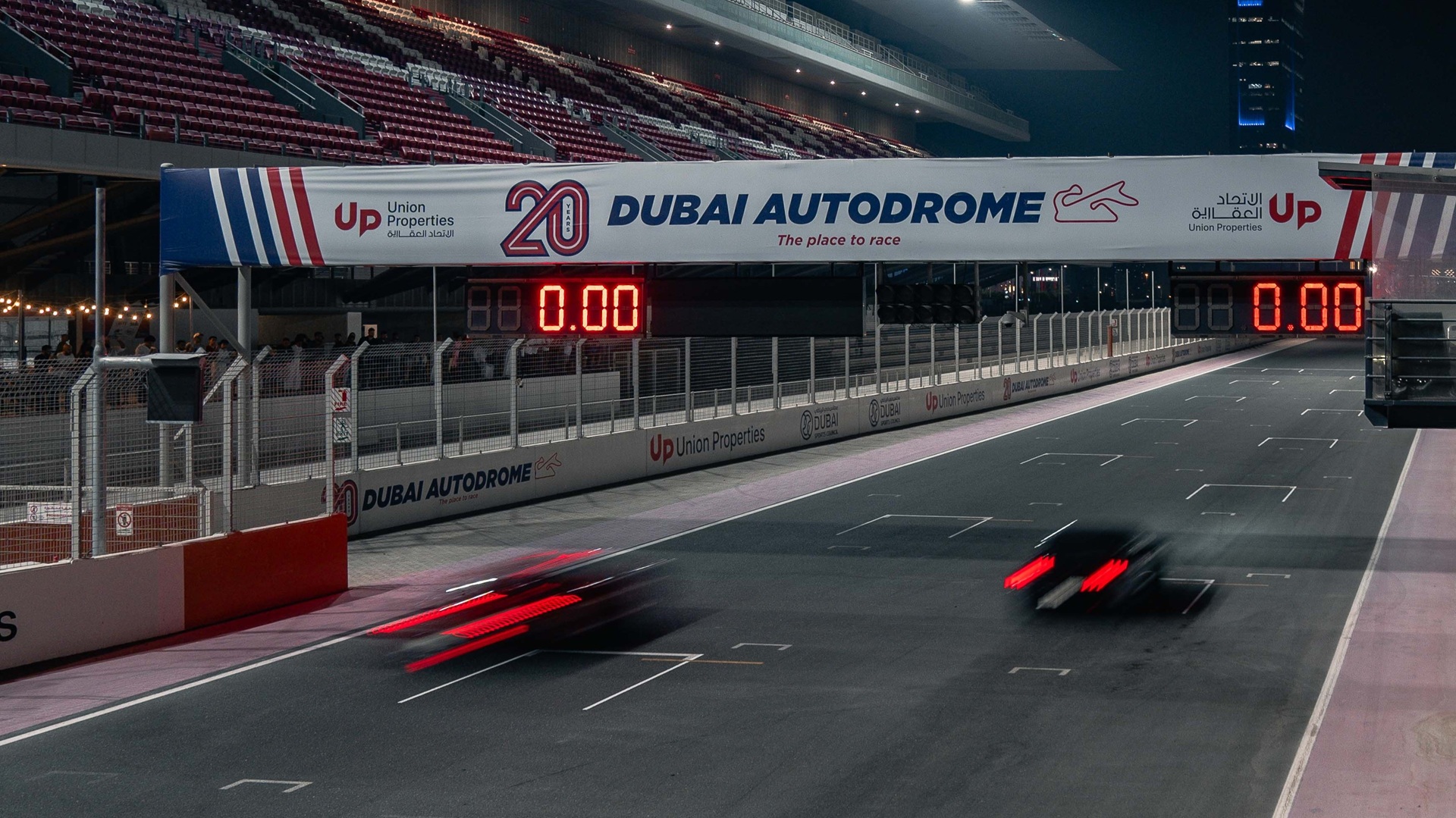 Cars going past the starting grid at speed at Dubai Autodrome