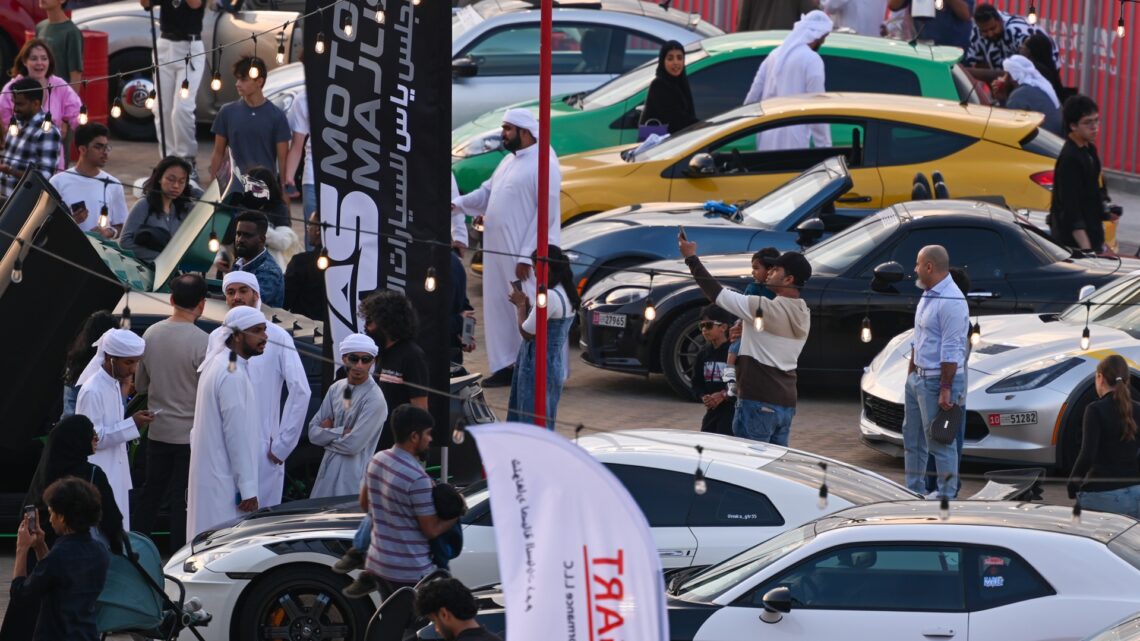 Wide shot of the gathering of people and cars during Yas Speed Festival