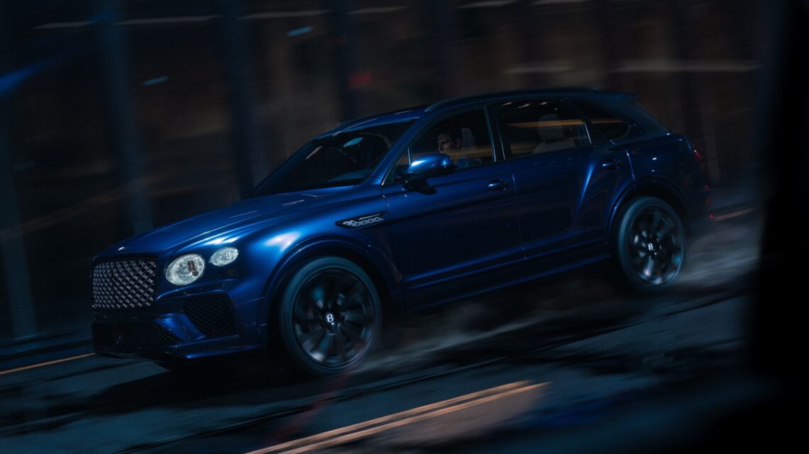 A dynamic photograph of a Sequin Blue Bentley Bentayga Artenara
