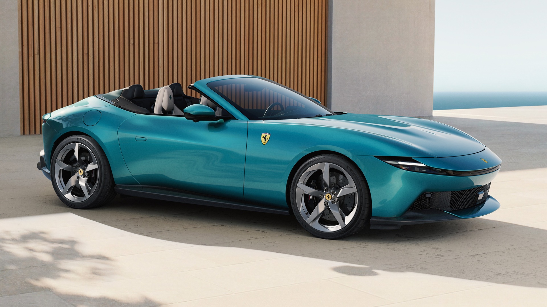 A static shot covering the front three-quarters of the new Ferrari Amalfi Spider in Verde Costiera colour