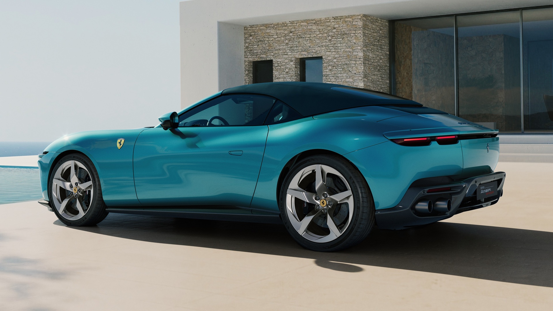 A static shot covering the rear three-quarters of the new Ferrari Amalfi Spider in Verde Costiera colour, with the roof closed