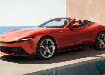 A static shot covering the front three-quarters of the new Ferrari Amalfi Spider in its exclusive Rosso Tramonto paint.