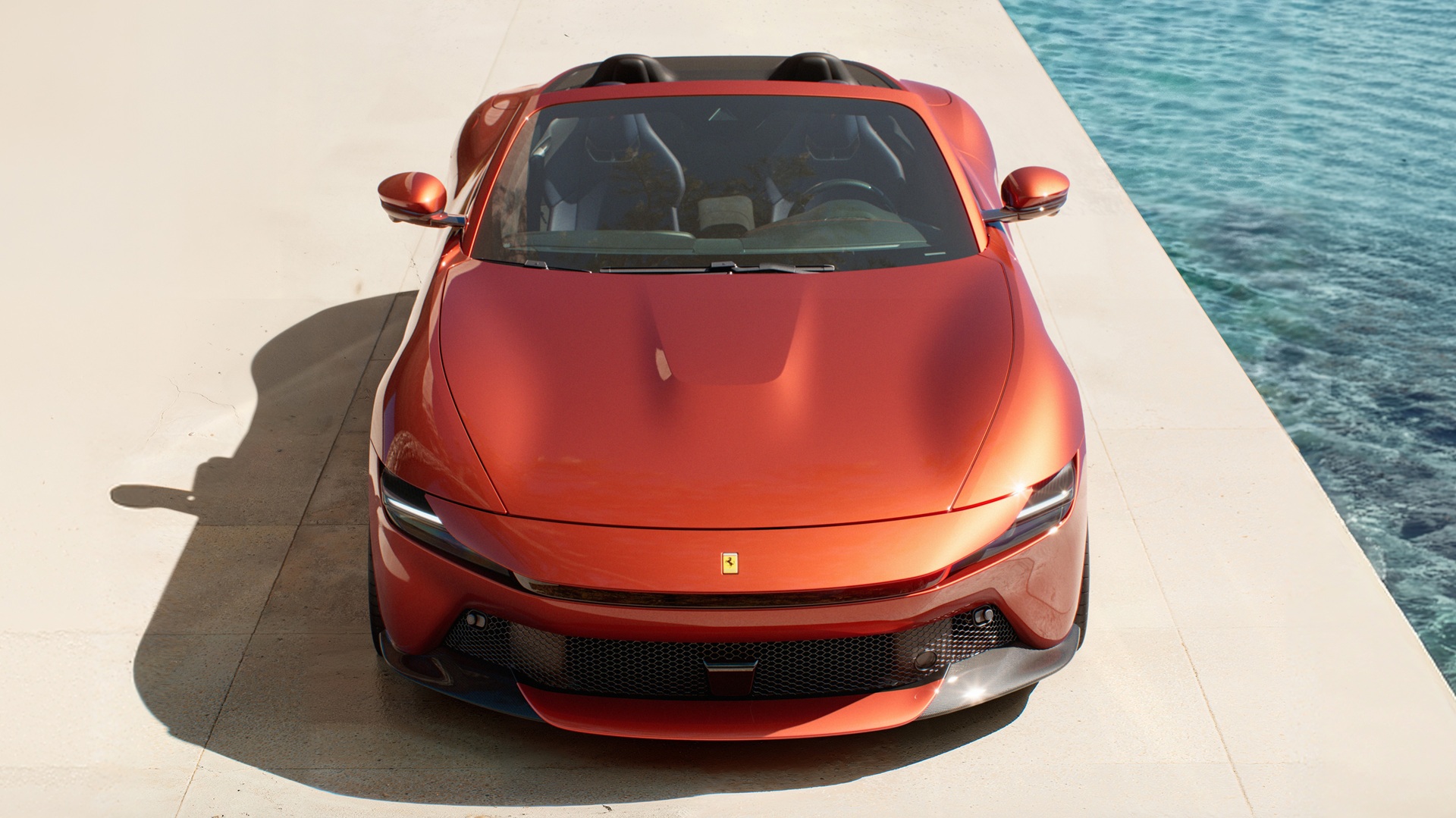 A static shot from front-top angle of the new Ferrari Amalfi Spider in its exclusive Rosso Tramonto paint.