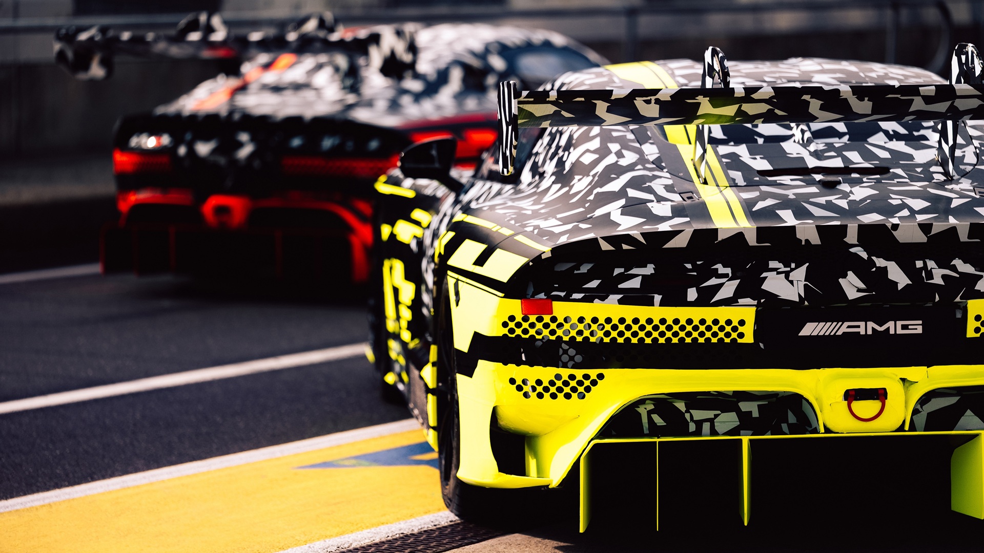 Mercedes-AMG testing the new GT3 and GT Black Series at the Nürburgring, with both cars heavily camouflaged and in the pit lane