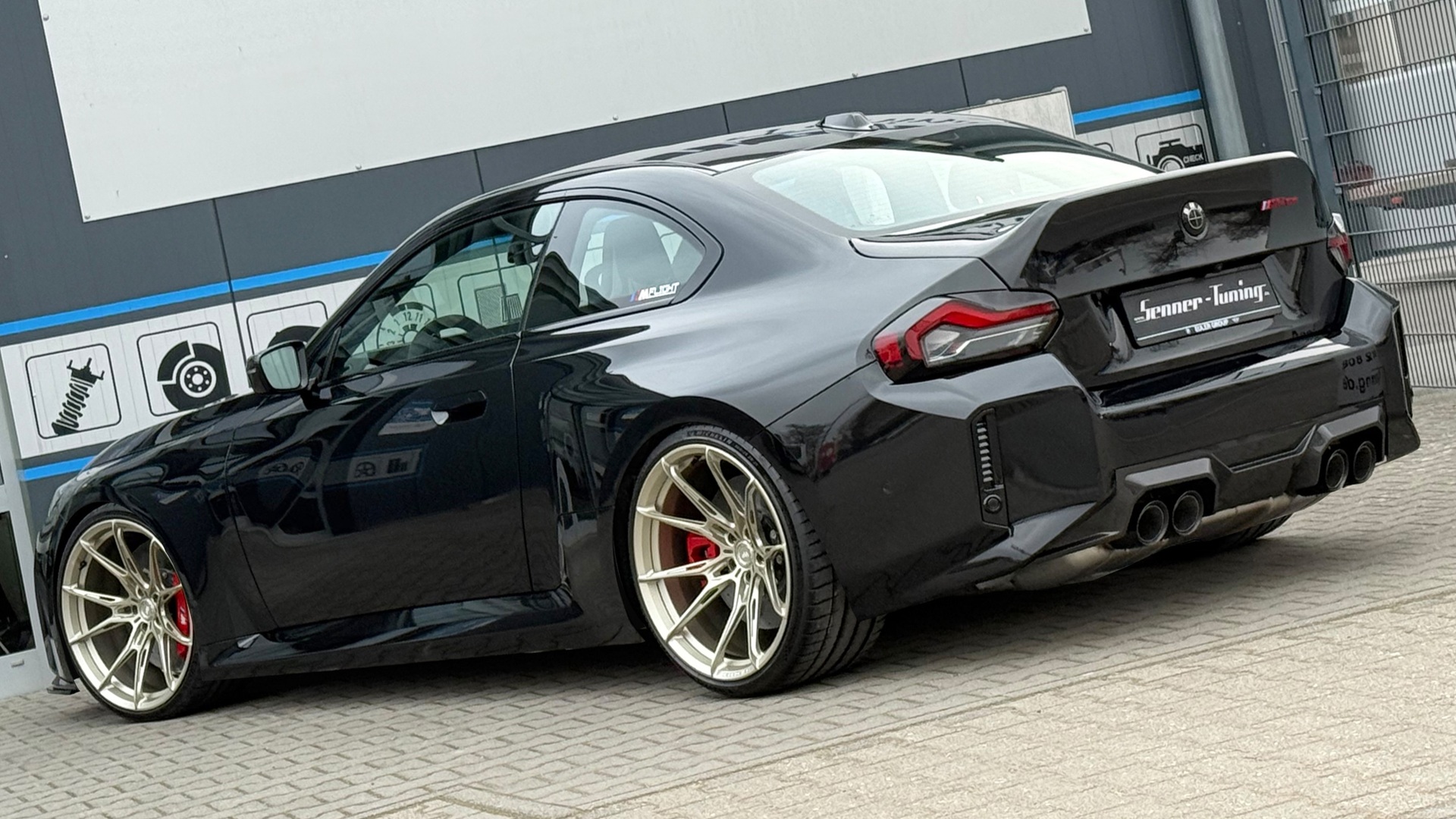 Rear three-quarters of a BMW M2 CS, created by Senner Tuning.