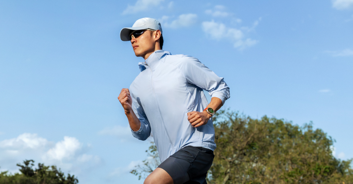 A runner wearing the HUAWEI WATCH GT Runner 2 in Dawn Orange