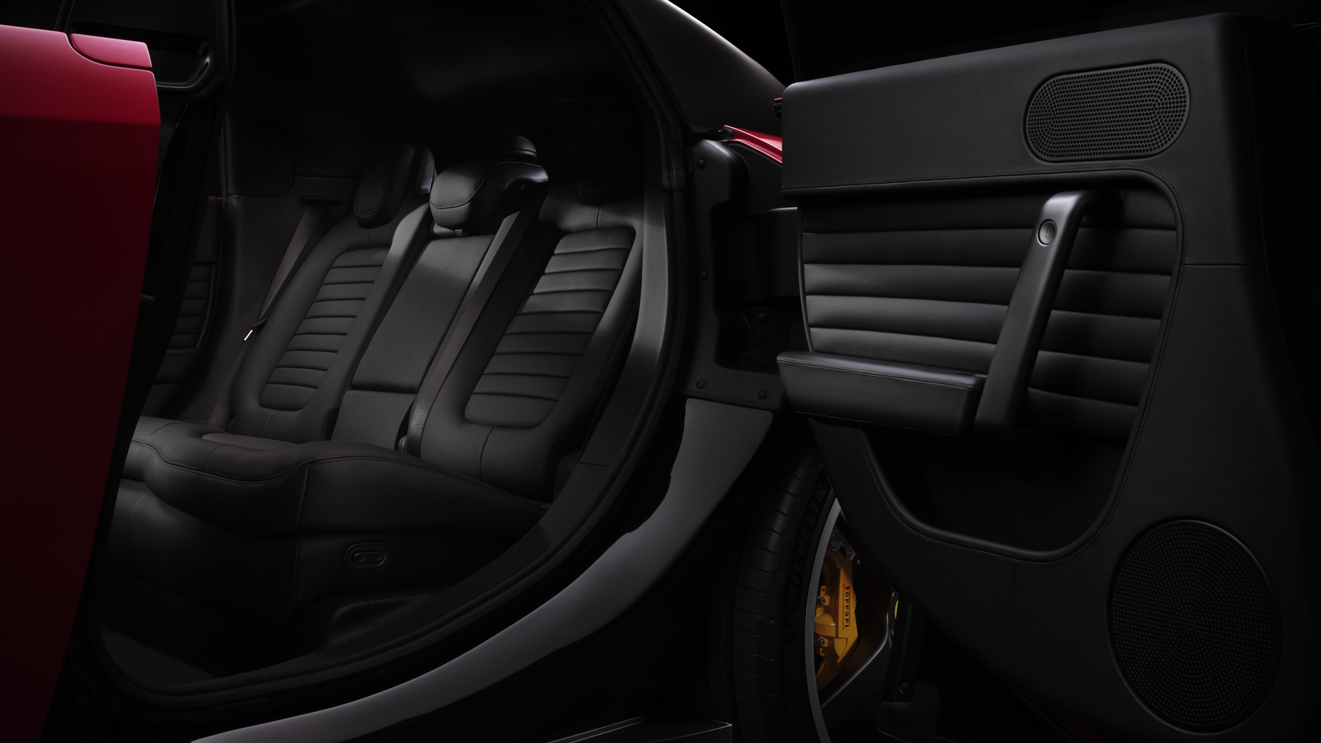 A studio shot of the Ferrari Luce in Rosso Fiammante, focusing on the rear seats