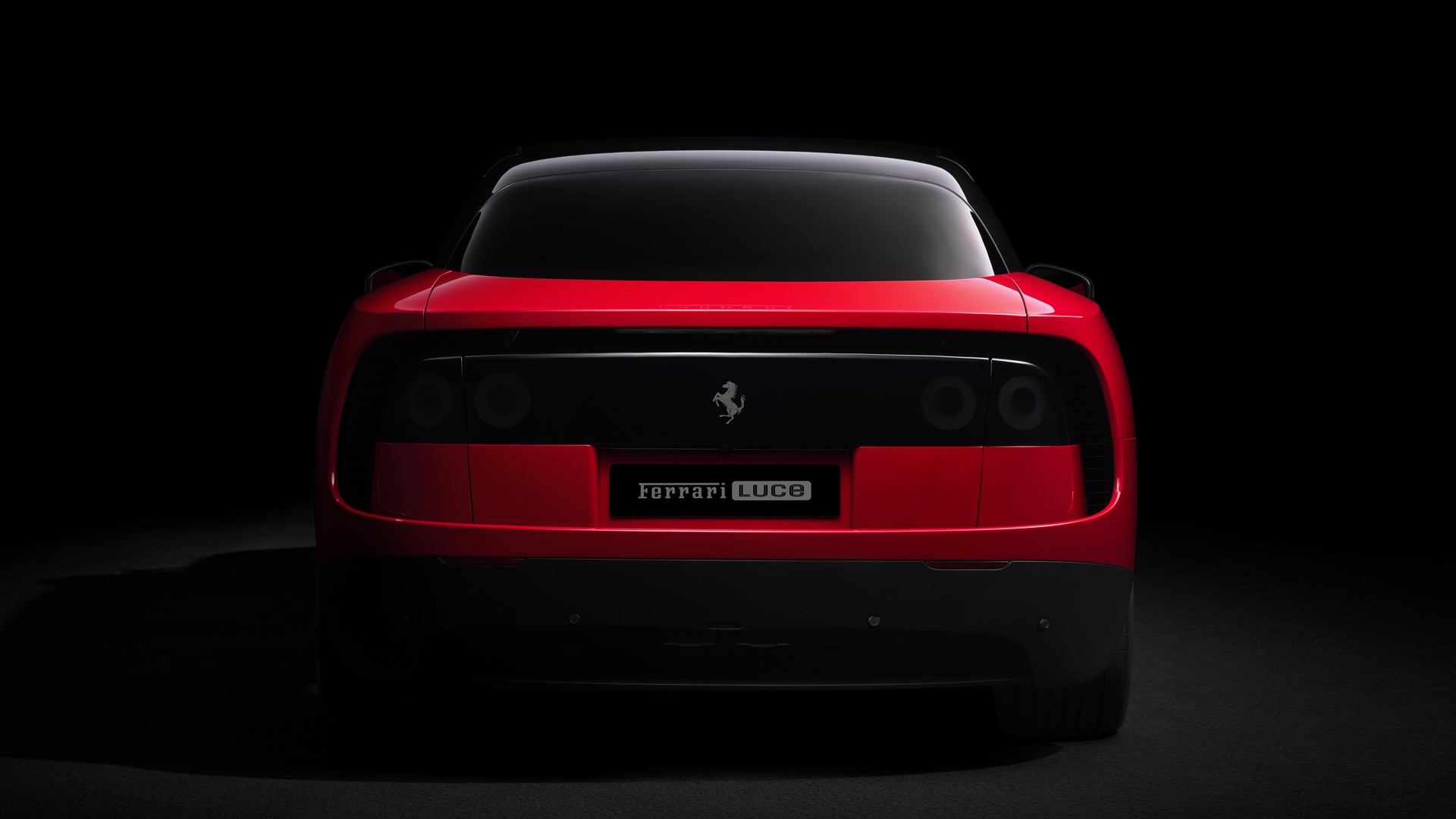 A studio shot of the Ferrari Luce in Rosso Fiammante, taken from the rear