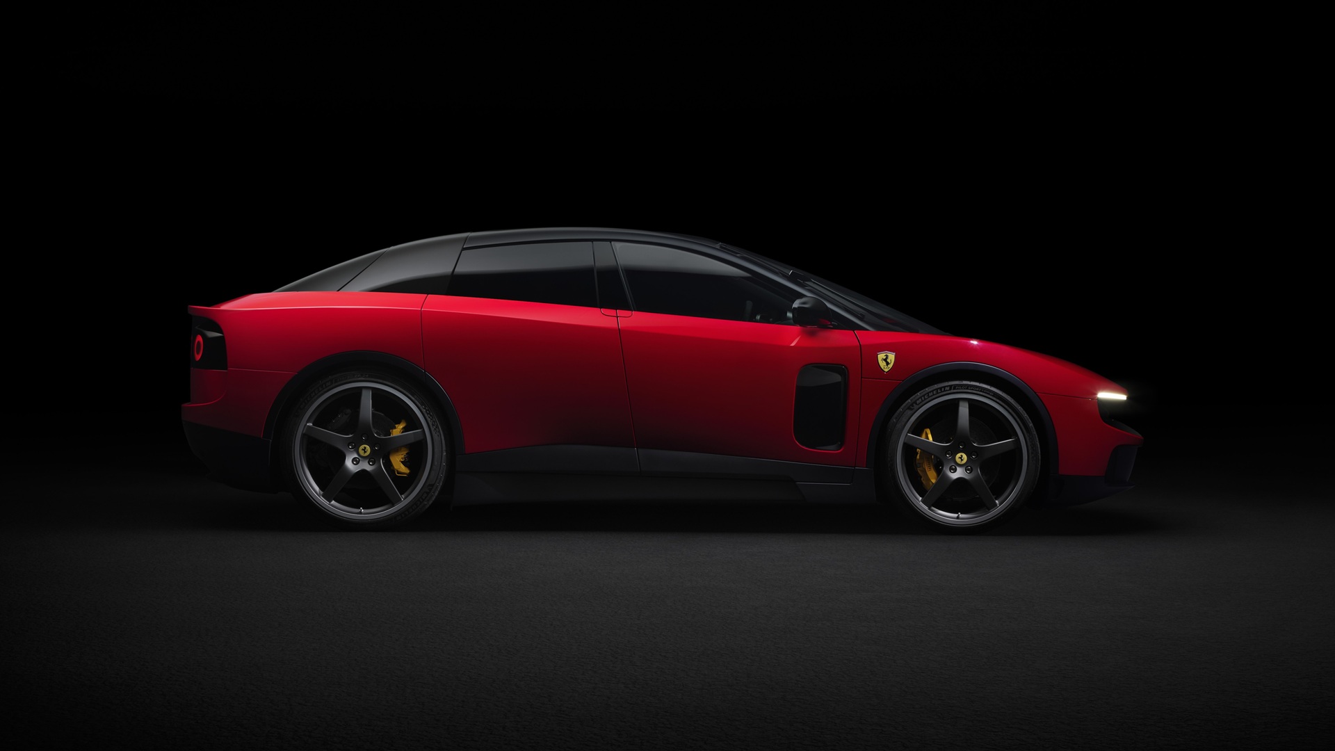 A studio shot of the Ferrari Luce in Rosso Fiammante, taken from the side