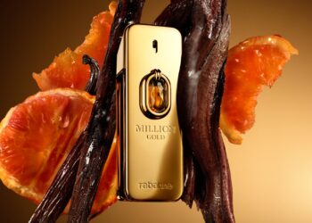 Image of the bottle of Million Gold Elixir, surrounded Yellow Mandarin and Vanilla