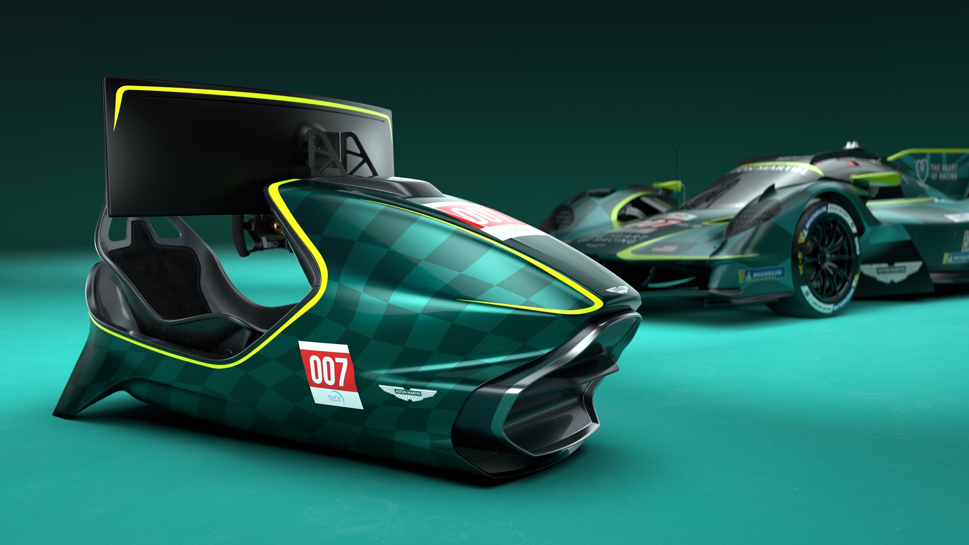 The 007 version of the Aston Martin Valkyrie Simulator with a Valkyrie hypercar in the back. The limited-run variant is the AMR-C01-R Hypercar Edition.