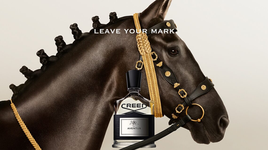 An image of the Creed Aventus bottle placed next to a horse.