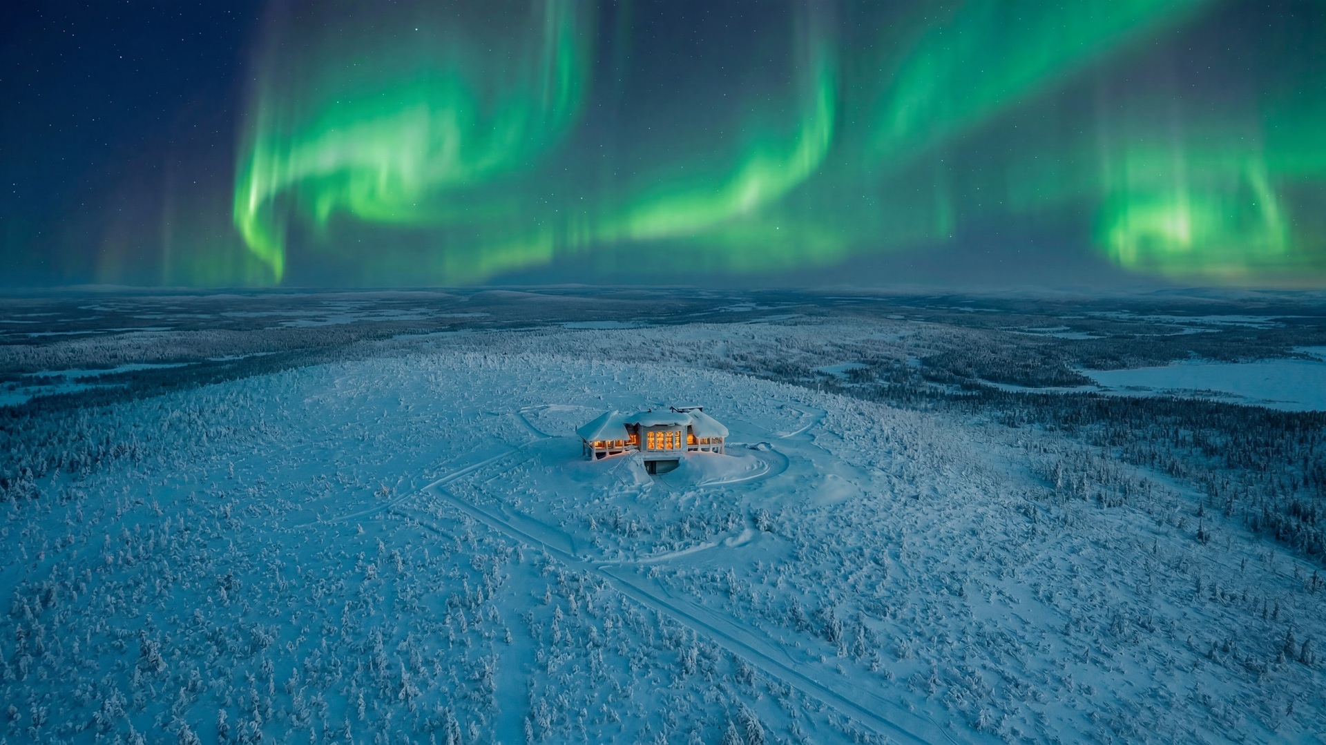 Aerial wide shot of the Octola III, located in the Finnish Lapland, under the Northern lights