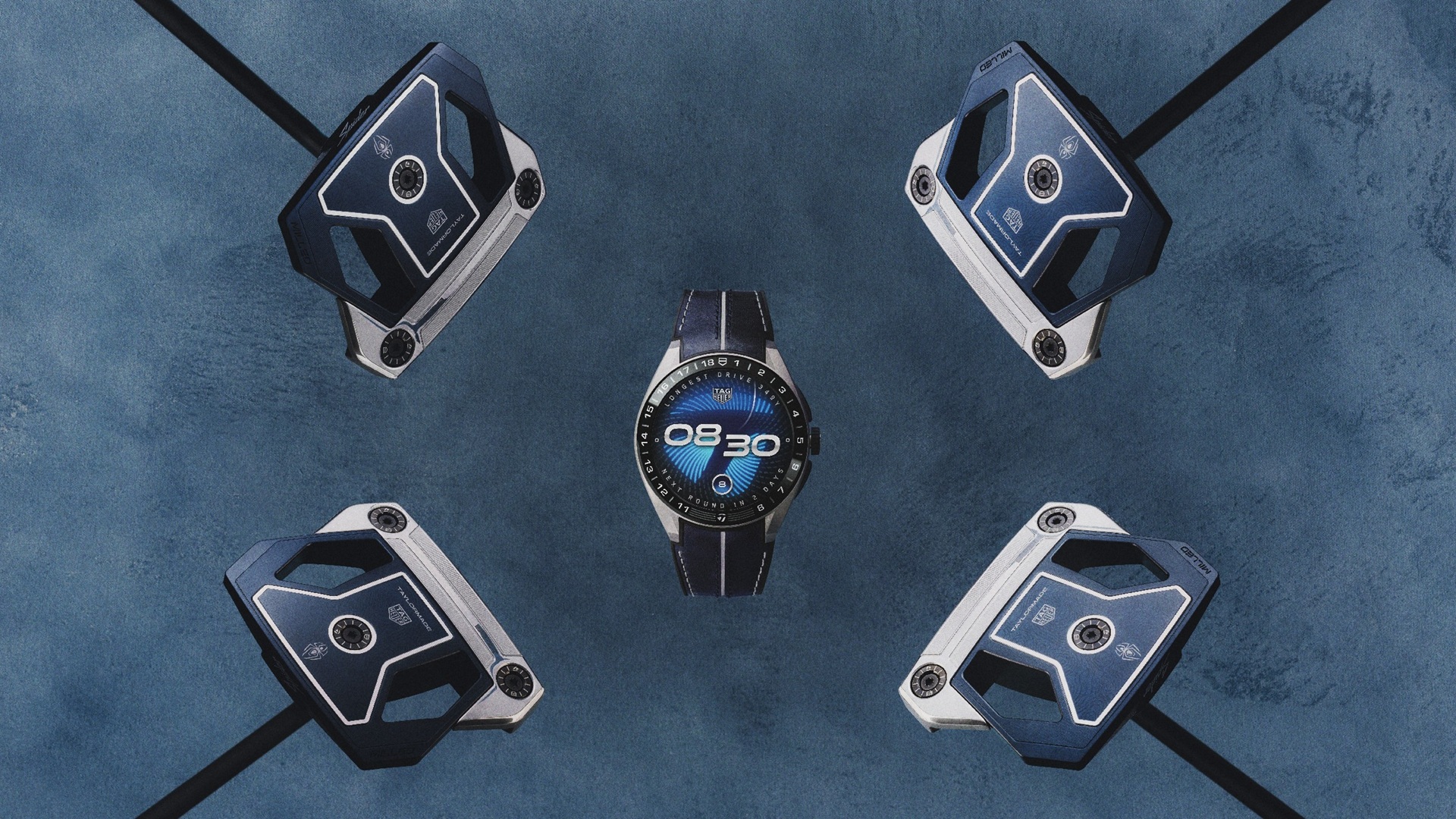 The TAG Heuer TaylorMade Watch, also known as TAG Heuer Connected Calibre E5 45 mm x TaylorMade Edition, placed at the centre with four golf clubs around it