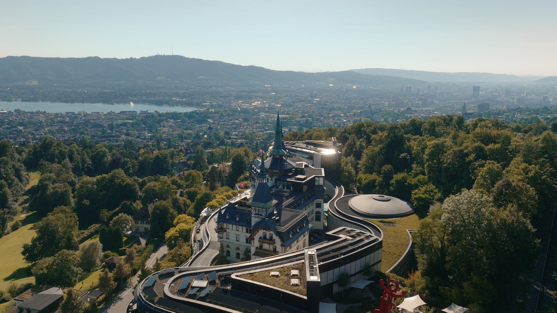 A wide-view exterior shot of The Dolder Grand Zurich from the right side