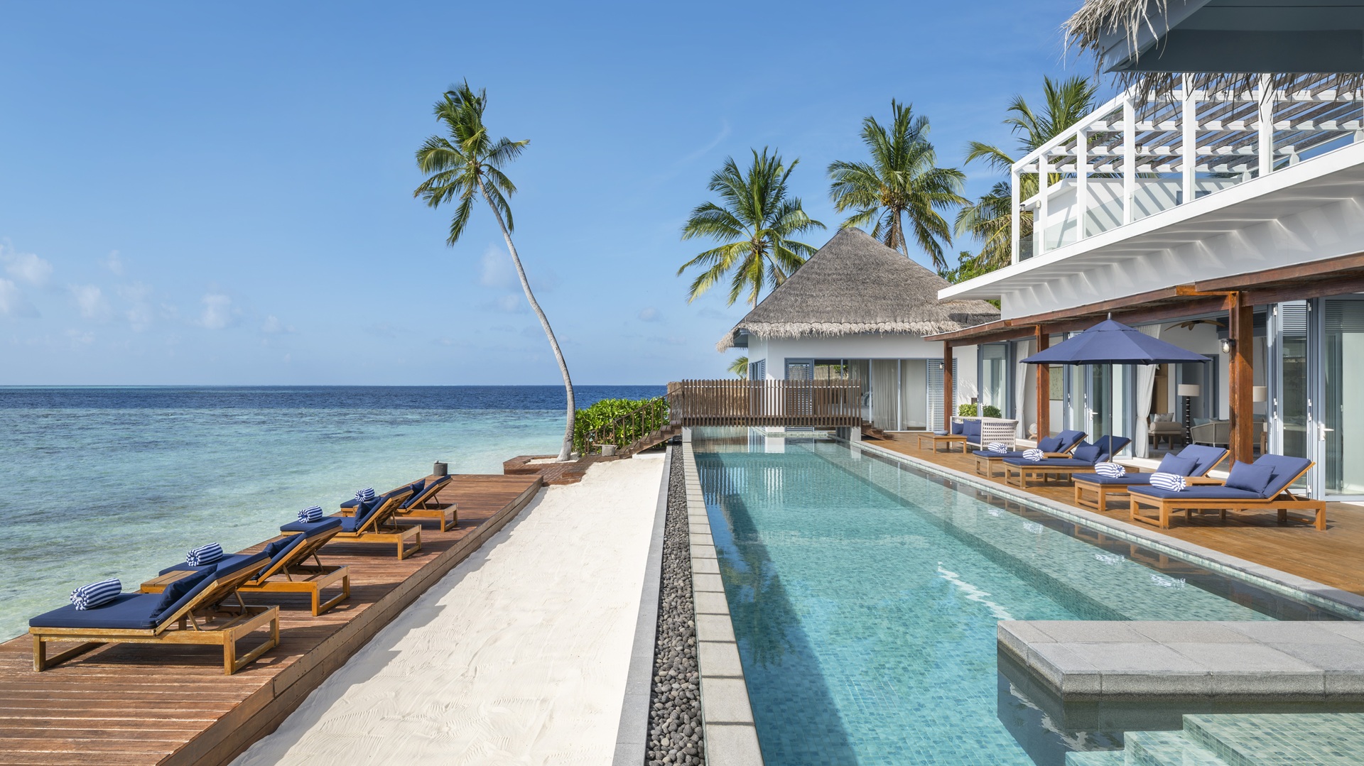 The outdoors, alongside the swimming pool, of the Halcyon Grand Estate at The Halcyon Private Isles Maldives