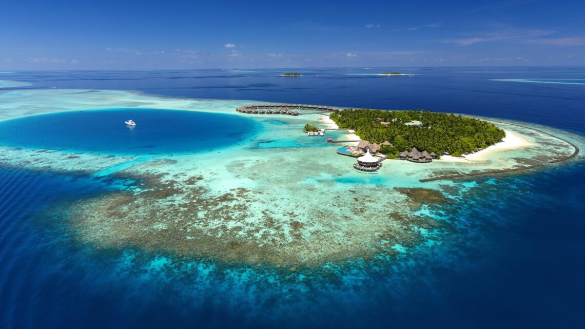 An aerial wide shot of the Baros Maldives Villas