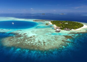 An aerial wide shot of the Baros Maldives Villas