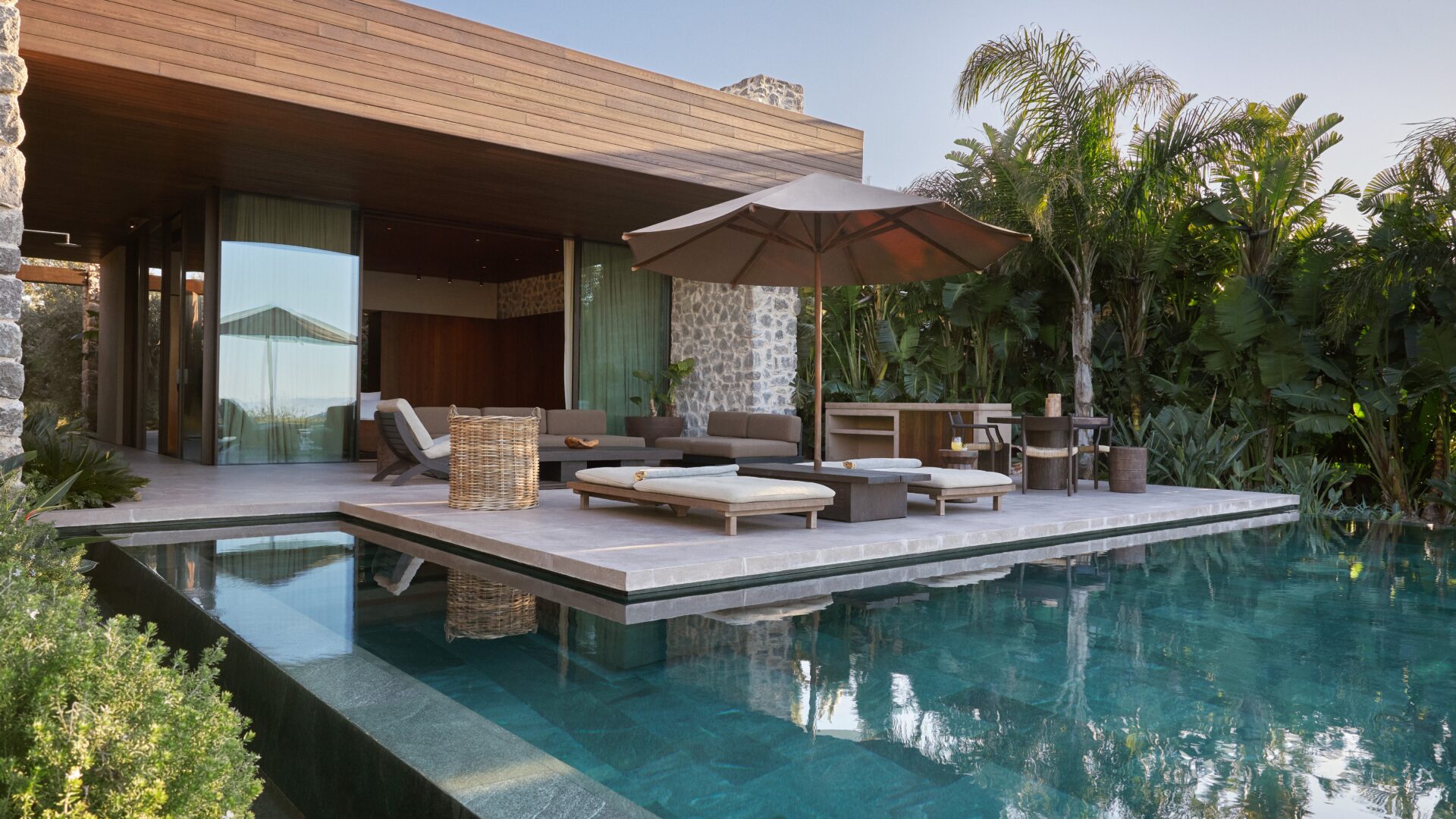 Maxx Royal Bodrum Villas: An image of the infinity pool with the sitting areas next to it.