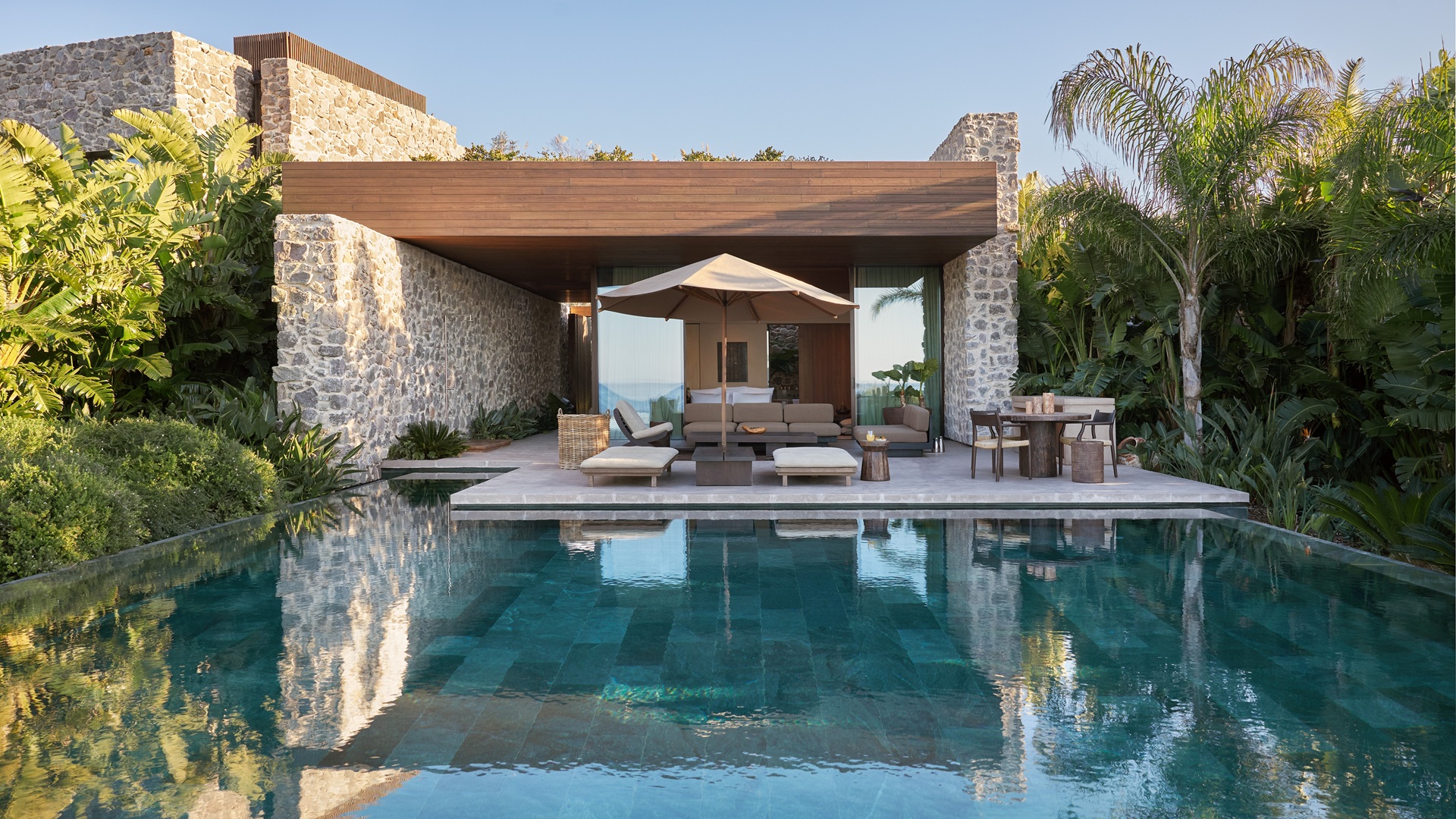 Maxx Royal Bodrum Villas: An image of the infinity pool with the sitting areas next to it.
