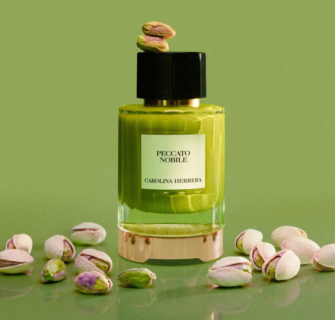 Carolina Herrera Peccato Nobile: A bottle of the scent surrounded by a pistachios