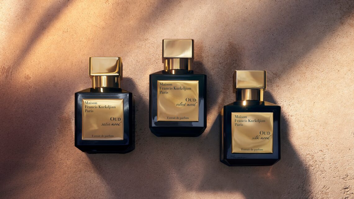 Maison Francis Kurkdjian Oud Velvet Mood: An image of three bottles kept side by side on what appears to be desert sand.