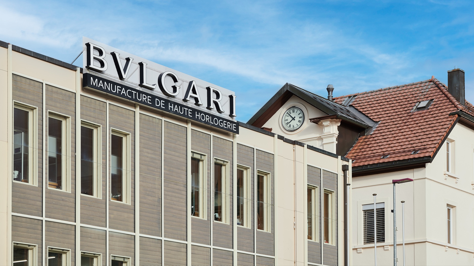Bvlgari Watchmaking - Le Sentier: An exterior shot, with a close-up on the signage, of the manufacturing facility where Bvlgari makes its watches.