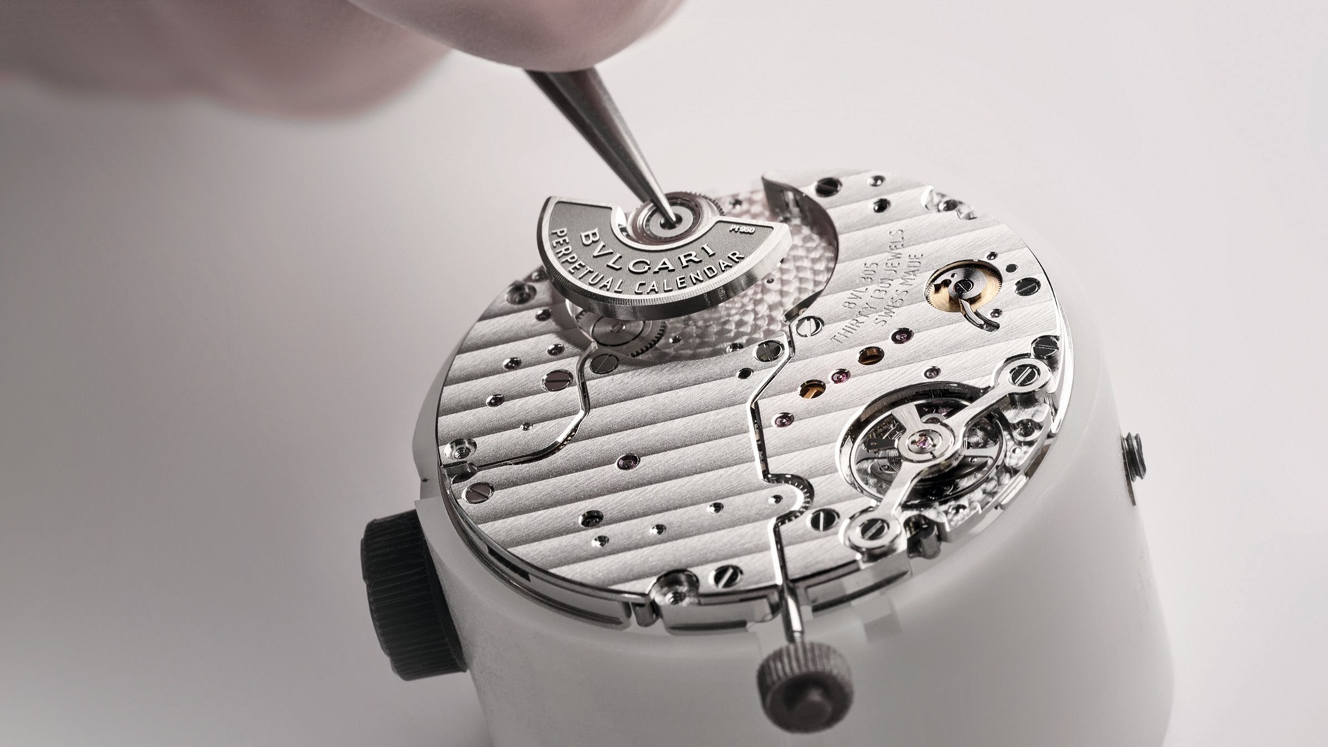 Bvlgari Watchmaking: A close-up image of a watch being assembled.
