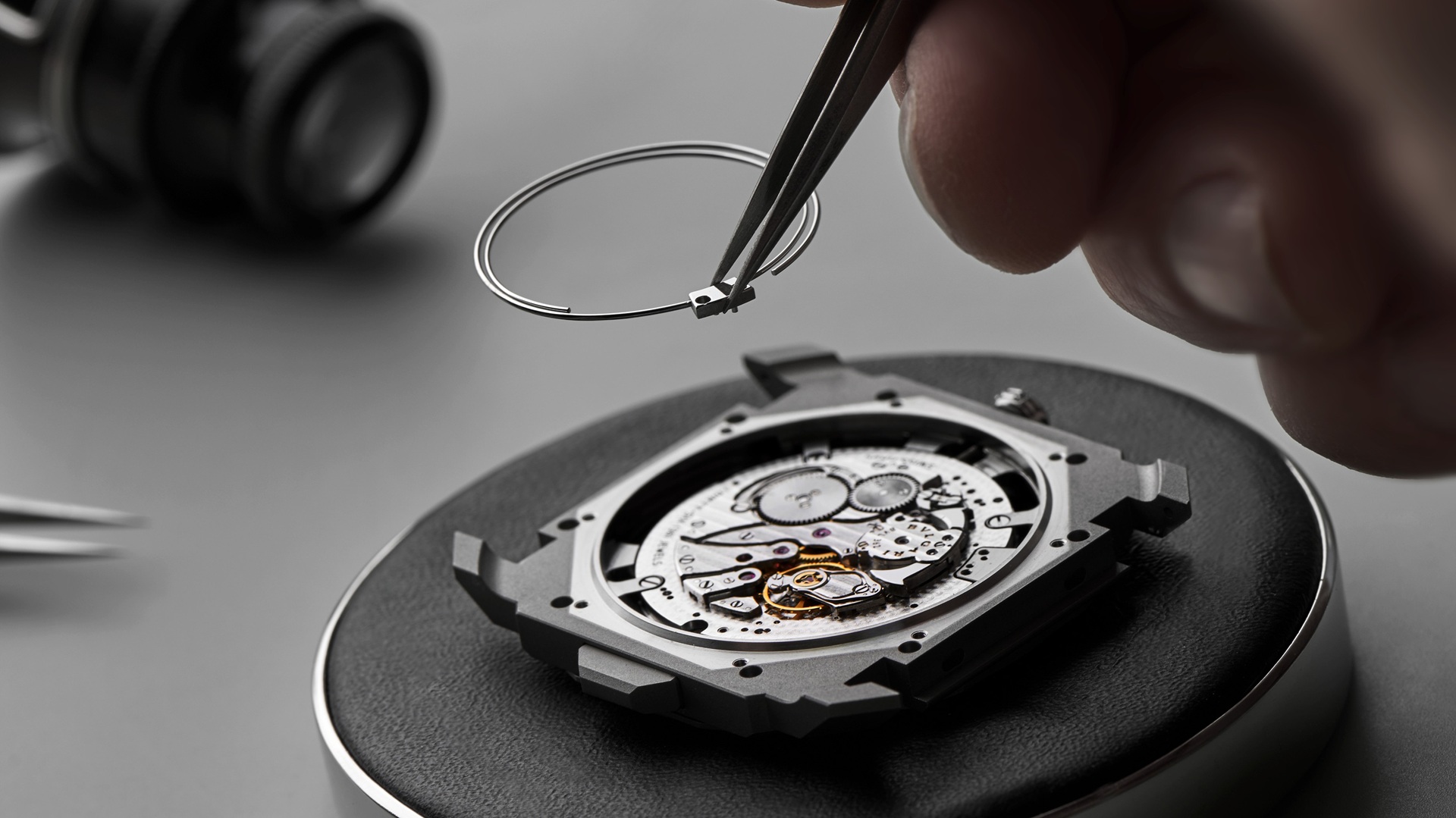 Bvlgari Watchmaking: A close-up image of a watch being assembled.
