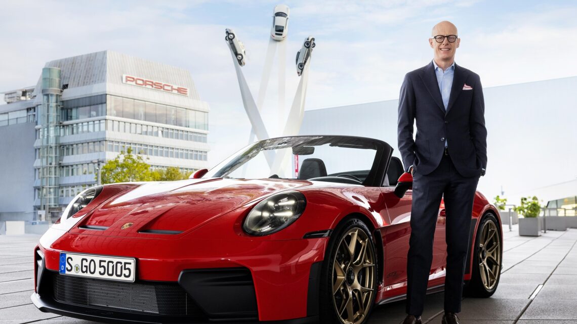 Porsche Strategy 2035: Dr. Michael, Chairman of the Executive Board of the Porsche AG, standing next to a red Porsche 911 Cabriolet